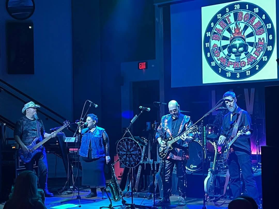 Dart Board Compromise full band portrait in front of their neon dartboard logo