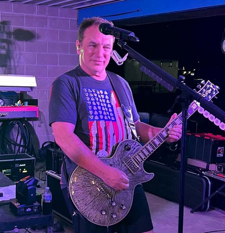 DBC guitarist performing outdoors
